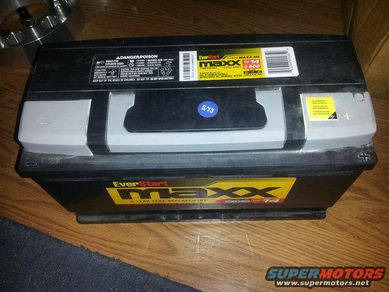 EverStart Maxx car battery with a 5/13 sticker and hazard warnings