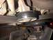 1994 Ford Bronco - This image shows engine components, specifically a belt tensioner and pulleys, with a watermark from SUPERMOTORS.NET.