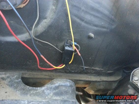 Automotive relay with red, yellow, and blue wires connected