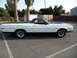 1973 Ford Ranchero - Side profile of a white 1973 Ford Ranchero pickup truck a black vinyl bed cover and racing stripes on the hood.