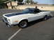 1973 Ford Ranchero - White 1973 Ford Ranchero with black accents and aftermarket wheels sits in a parking lot.