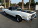 1973 Ford Ranchero - A white 1973 Ford Ranchero with a black hood stripe is parked outdoors.