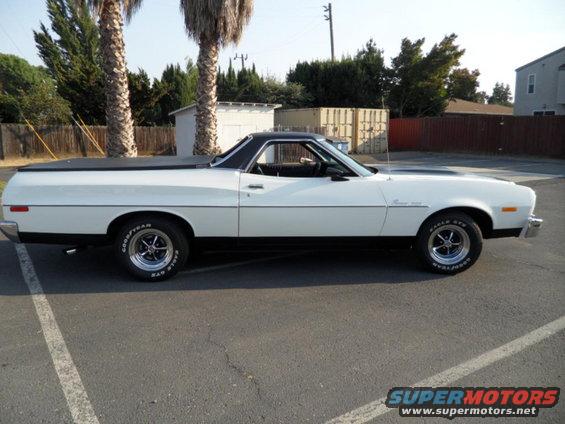 White 1973 Ford Ranchero side view with black bed cover and racing stripes