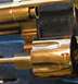 1968 Mercury Cougar - Close-up of a revolver cylinder and barrel, showing metallic finish and some engraved text.