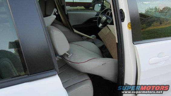 Interior view of a white minivan with seats folded and a box