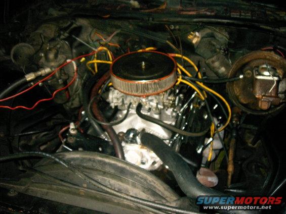 Engine bay with V8 engine, carburetor, and air cleaner. No visible year indicators
