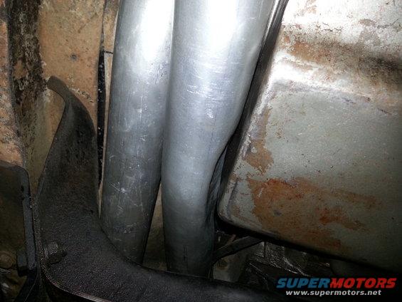 Dual exhaust pipes and undercarriage components of a vehicle
