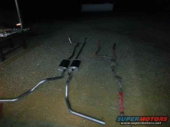 New and old exhaust systems laid out on the ground