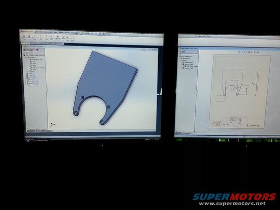 CAD drawing of a metal bracket on computer screens