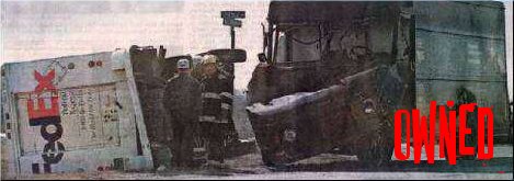Two damaged FedEx trucks, one overturned, with firefighters present