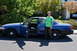 2006 Ford Crown Victoria - A man poses with his blue 2006 Ford Crown Victoria, its doors open to reveal the interior.