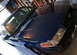 2006 Ford Crown Victoria - A dark blue sedan is parked in a garage, showing its front quarter and side profile.