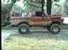 1979 Ford Bronco - This lifted Ford Bronco is parked on a driveway with its hood open, showing off its off-road capabilities.