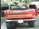 1979 Ford Bronco - The rear of a red SUV is shown with its doors open, revealing its interior.