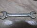 2004 Aston Martin Virage - This is a close-up shot of a single combination wrench with visible markings.