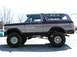 1979 Ford Bronco - This lifted 1978 Ford Bronco features a two-tone maroon and silver paint scheme and aggressive off-road tires.