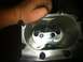 2003 Ford Crown Victoria - A hand is shown over the intake of a supercharger, revealing its internal rotors.