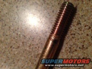 Close-up of a threaded bolt with SuperMotors.net logo
