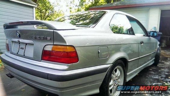 Silver 1997 BMW 323is coupe, rear 3/4 view, parked in driveway