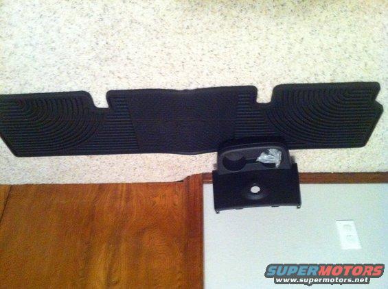 Black floor mats and center console part with cupholders