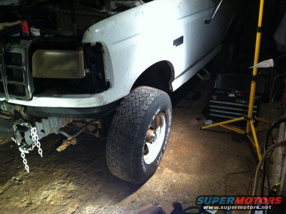 1992 Ford Bronco front end with headlight removed, showing grille and tire