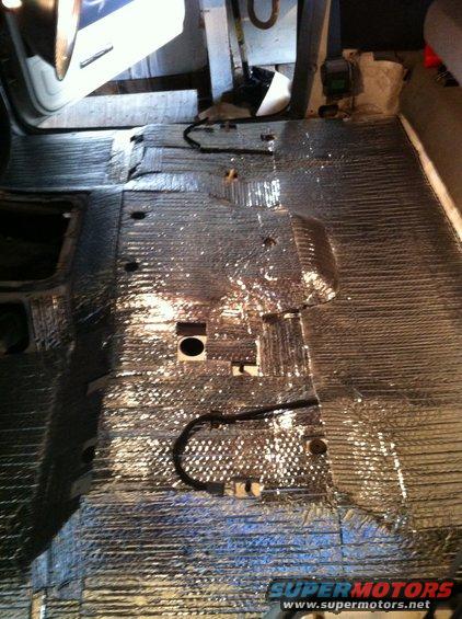 Vehicle floor with silver insulation and black wiring