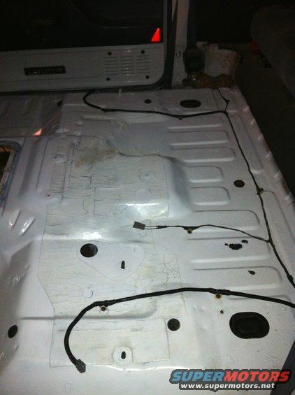 Interior floor of a vehicle with exposed wiring. A label reads 'F150'