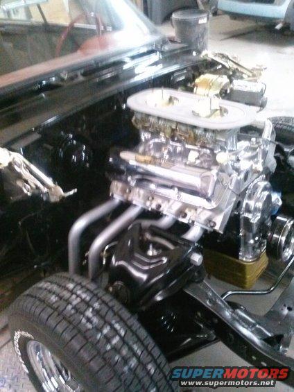 Engine bay with V8 engine, dual carburetors, and chrome headers. 1960 Ford Falcon not visible