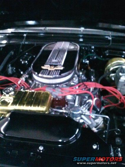 Engine bay with chrome air cleaner, gold valve covers, and red spark plug wires