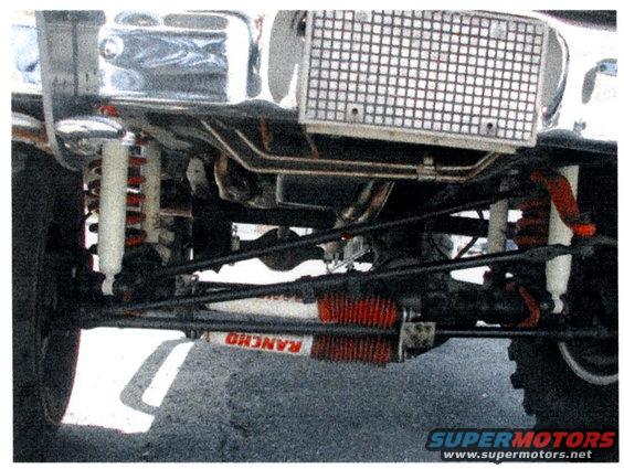 Undercarriage view of a vehicle showing Rancho shocks and suspension parts
