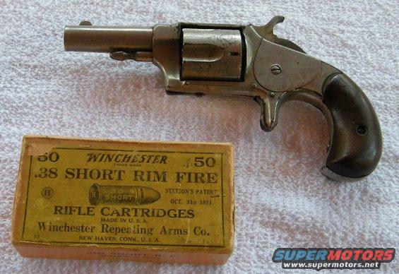 Antique revolver next to a box of Winchester .38 Short Rim Fire rifle cartridges