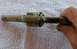 1968 Mercury Cougar - A hand holds a revolver cylinder with "AMERICAN" visible on its side.