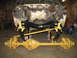 1989 Chevrolet C/K Pickup - The front end of a vehicle is disassembled, showing the suspension and drivetrain components.