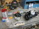 1989 Chevrolet C/K Pickup - Various automotive parts, including a reservoir and steering gear, are laid out on a workbench.
