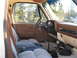 1989 Chevrolet C/K Pickup - Interior view of a pickup truck, showing the dashboard, seats, and gear shifter.