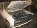 1989 Chevrolet C/K Pickup - The front grille and headlights of a white 1988 Chevrolet C/K Pickup are visible with the hood open.