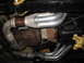 1989 Chevrolet C/K Pickup - Underside view of exhaust headers and transmission parts on a vehicle.