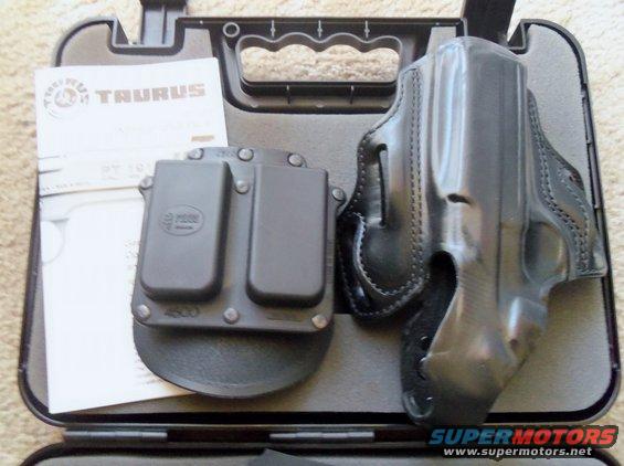 Taurus pistol holster, double magazine carrier, and manual in a black case