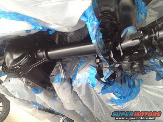 Rear axle and driveshaft covered in protective wrap and blue painter's tape