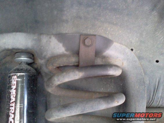 Coil spring and black Sensatrack shock absorber mounted on vehicle frame