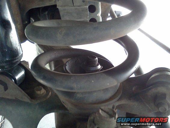 Front coil spring and shock absorber assembly