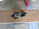 2005 Ford Excursion - Two vehicle suspension parts are shown on a wooden plank. The page claims they are from a 2005 Ford Excursion.