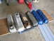 2005 Ford Excursion - A collection of various engine valve covers are laid out on a wooden board.