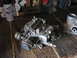 2005 Ford Excursion - Carburetor shown on a workbench next to a can of spray paint.