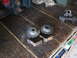 2005 Ford Excursion - Several used vehicle suspension components are laid out on a workbench.