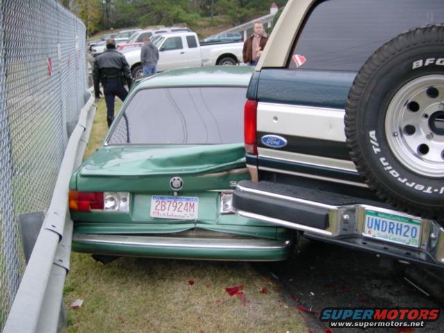 Green sedan rear-ended by Ford Bronco, both vehicles damaged. License plates visible