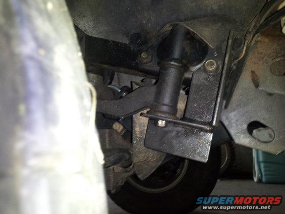 Underbody suspension components with a visible tire and part of the frame