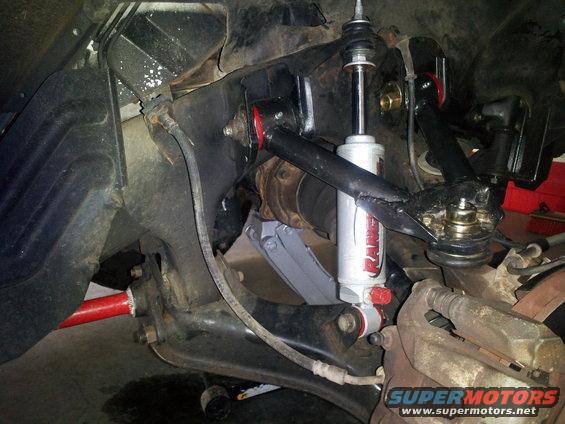 close-up of front suspension with new shock absorber and red sway bar
