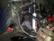 2003 Nissan Frontier - The front suspension system shows upgraded components, including a shock absorber and sway bar.