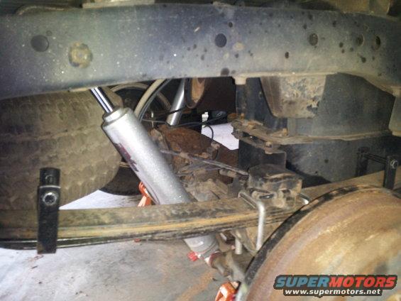 Rear leaf springs, shock absorber, and brake drum on a vehicle